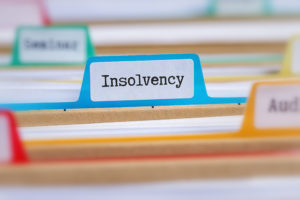 File folders with a tab labeled Insolvency