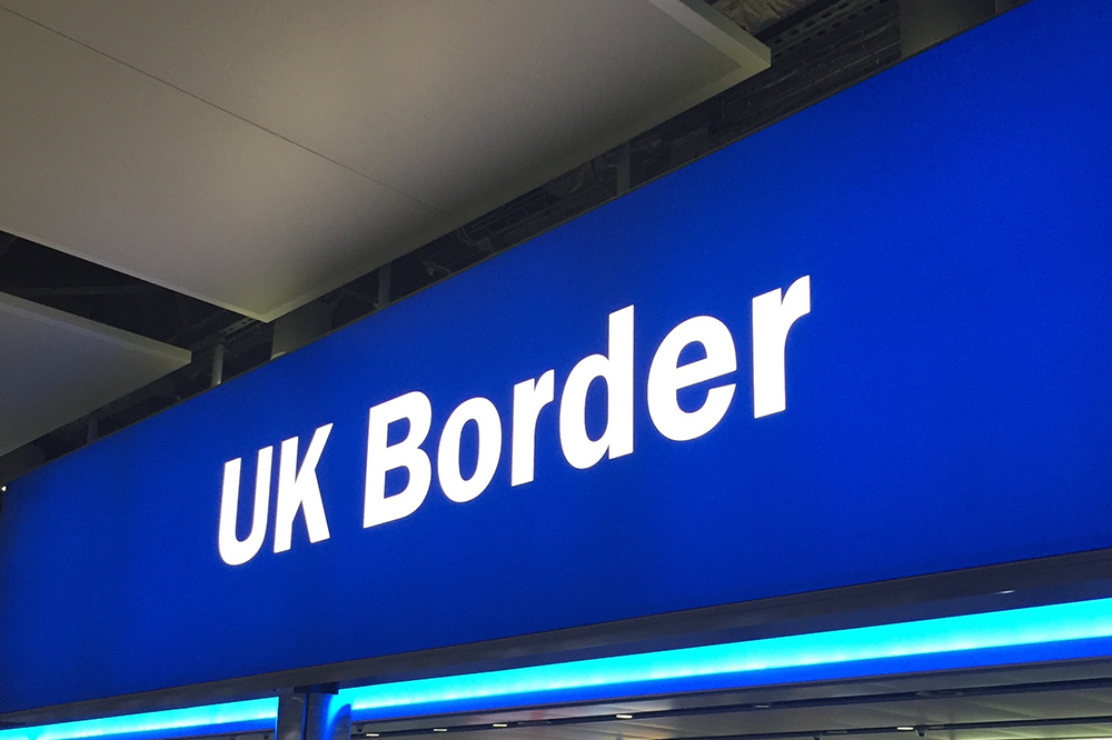 UK border sign white letters on blue